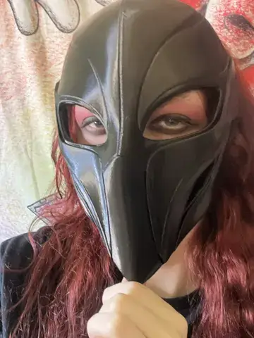 Dark fantasy mask worn with a hood and black costume